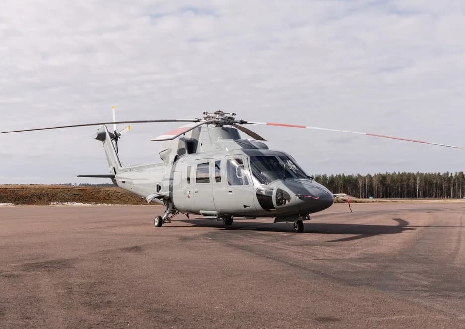 Front view of a gray helicopter parked on the tarmac.