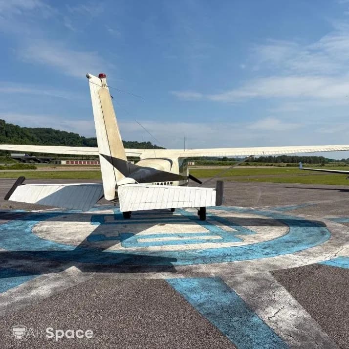 Rear view of a white and black Cessna 172 N8032T showing the tail and horizontal stabilizer.