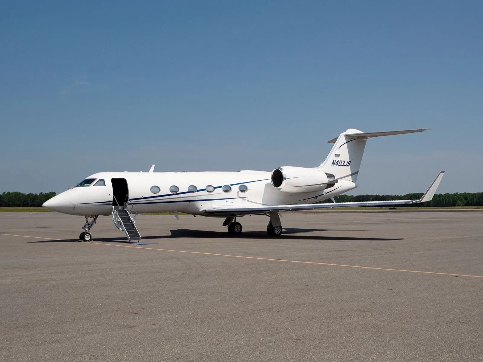 Gulfstream jet parked on the tarmac with airstair door open.