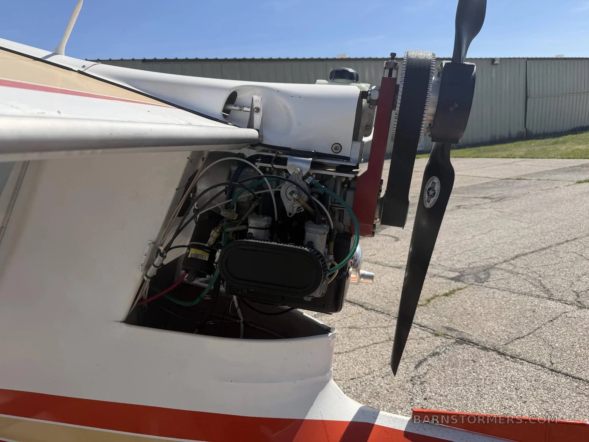 A close-up view of the exposed engine and propeller of a Challenger ultralight aircraft.