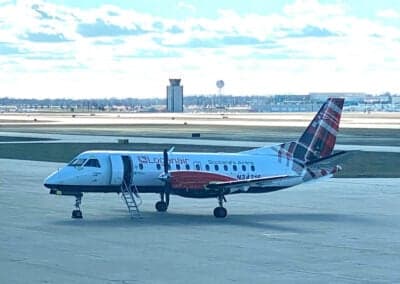Side view of a Loganair Beechcraft 1900 aircraft with a tartan tail on the tarmac.