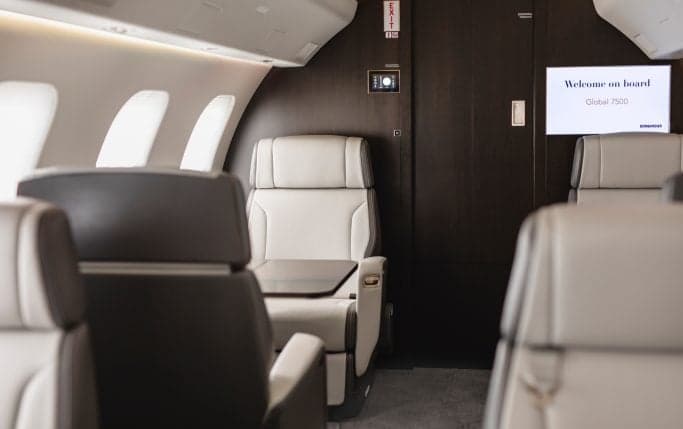 Close-up of the front of a Global 7500 aircraft with the door open and stairs extended.