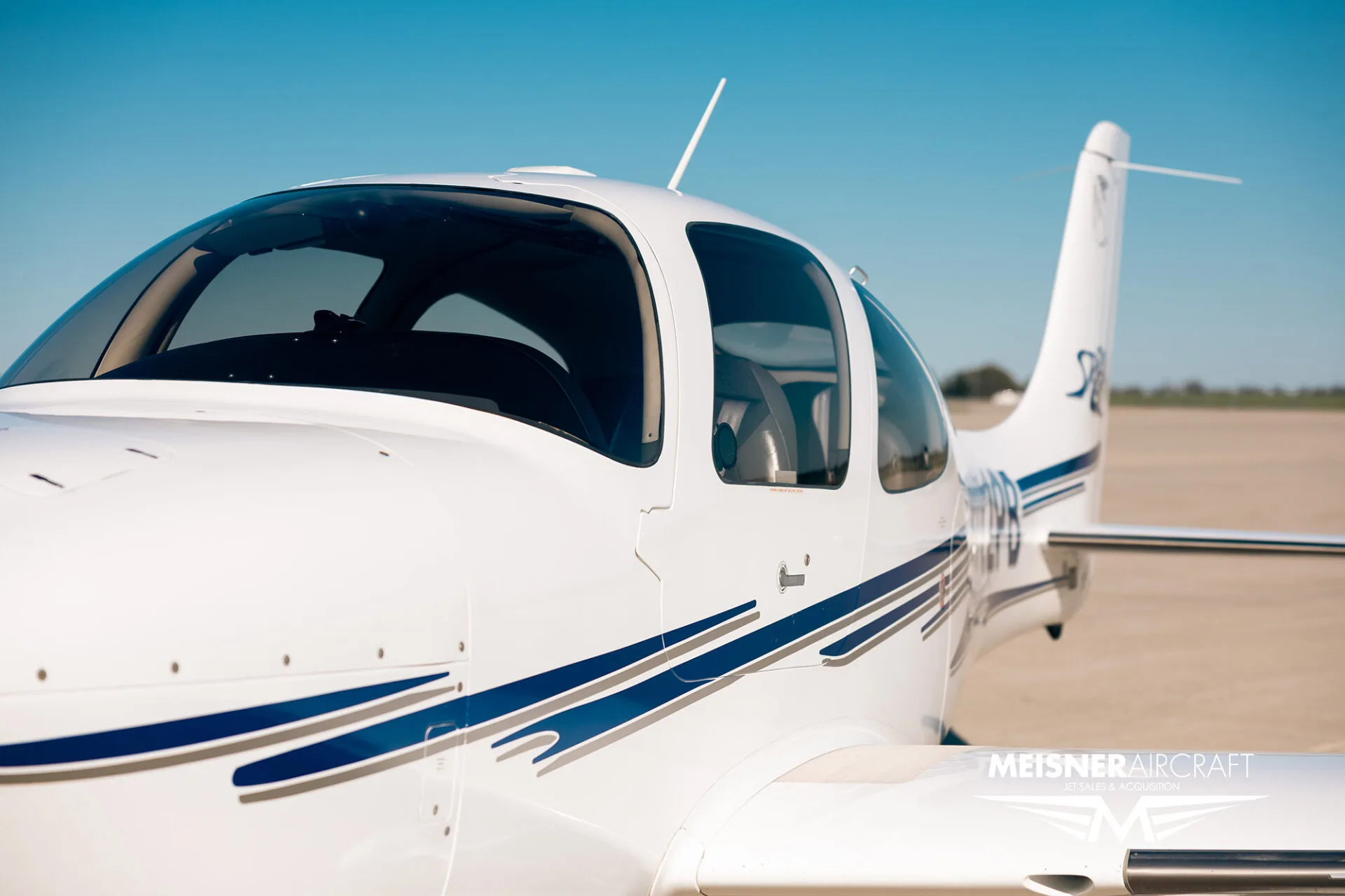 Close-up of the cockpit and wing of Cirrus SR22 aircraft, registration N722PB.
