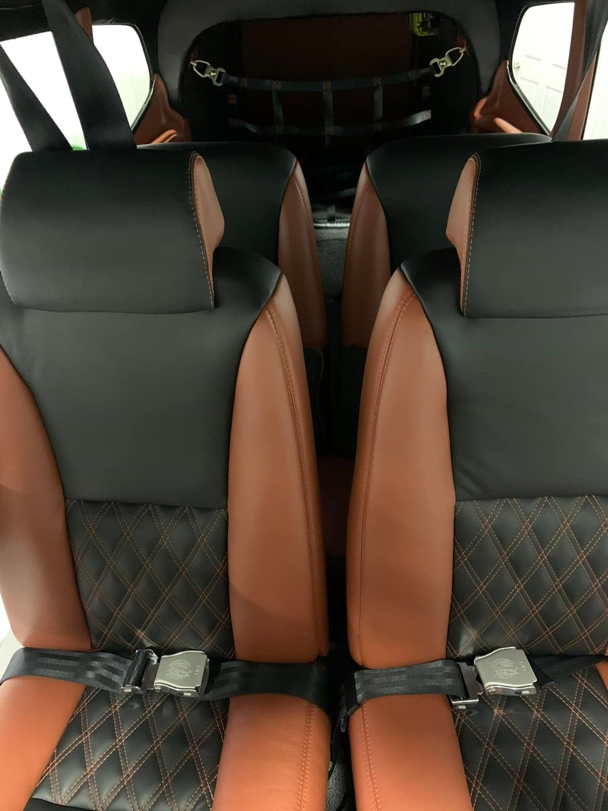 View of the black and tan leather seats in the aircraft cabin.