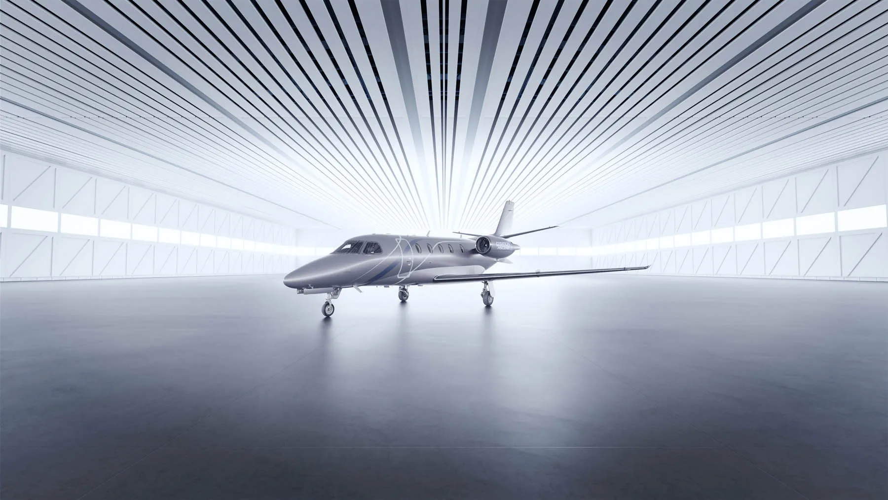 A light jet parked inside a hangar with bright lighting.