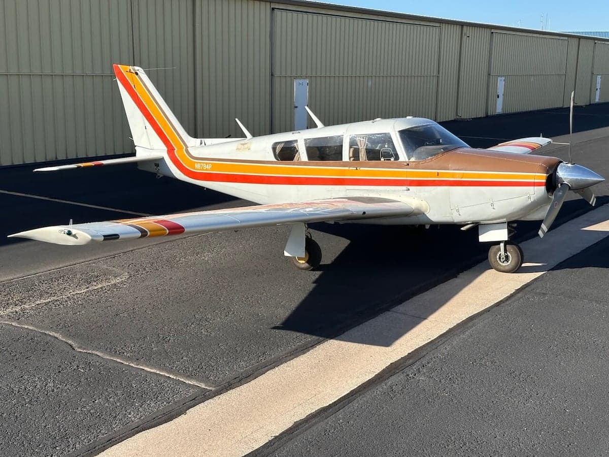 Side view of a Piper PA-28-181 Archer II aircraft on the tarmac.