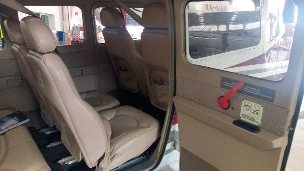 Interior of the Cessna XB-LRD, showing the seats and cabin from the open door.