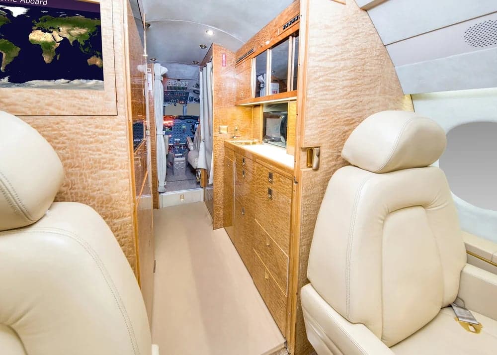 The interior of the Falcon aircraft features leather seats and wood paneling.