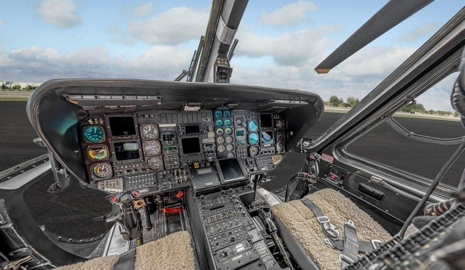 View of the instrument panel and controls in the cockpit of the helicopter.