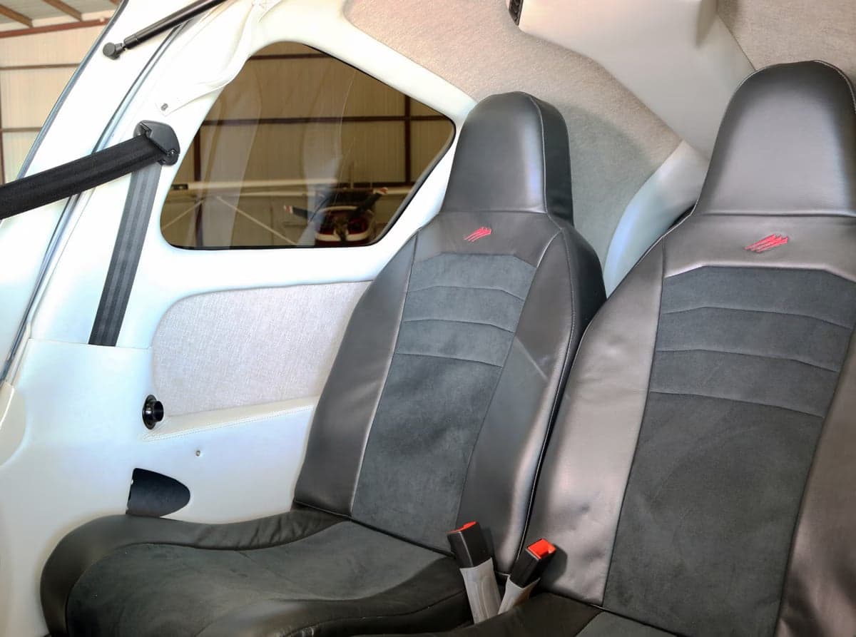 The cockpit of a Cirrus SR22T aircraft features dual screens and control sticks.