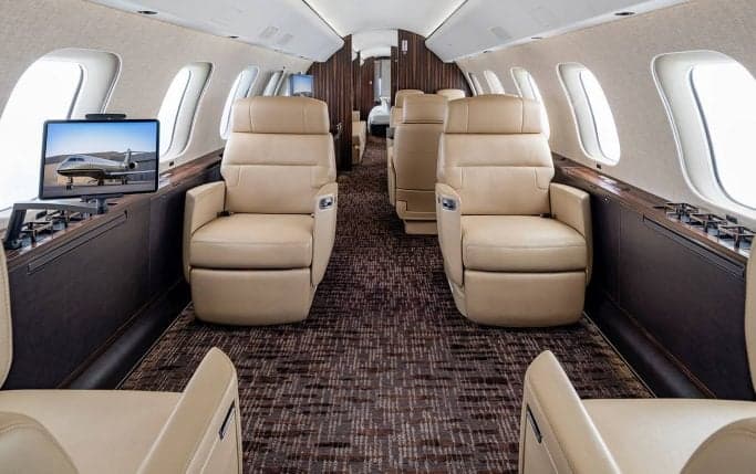 View of the aircraft interior showing wood cabinetry and seating.