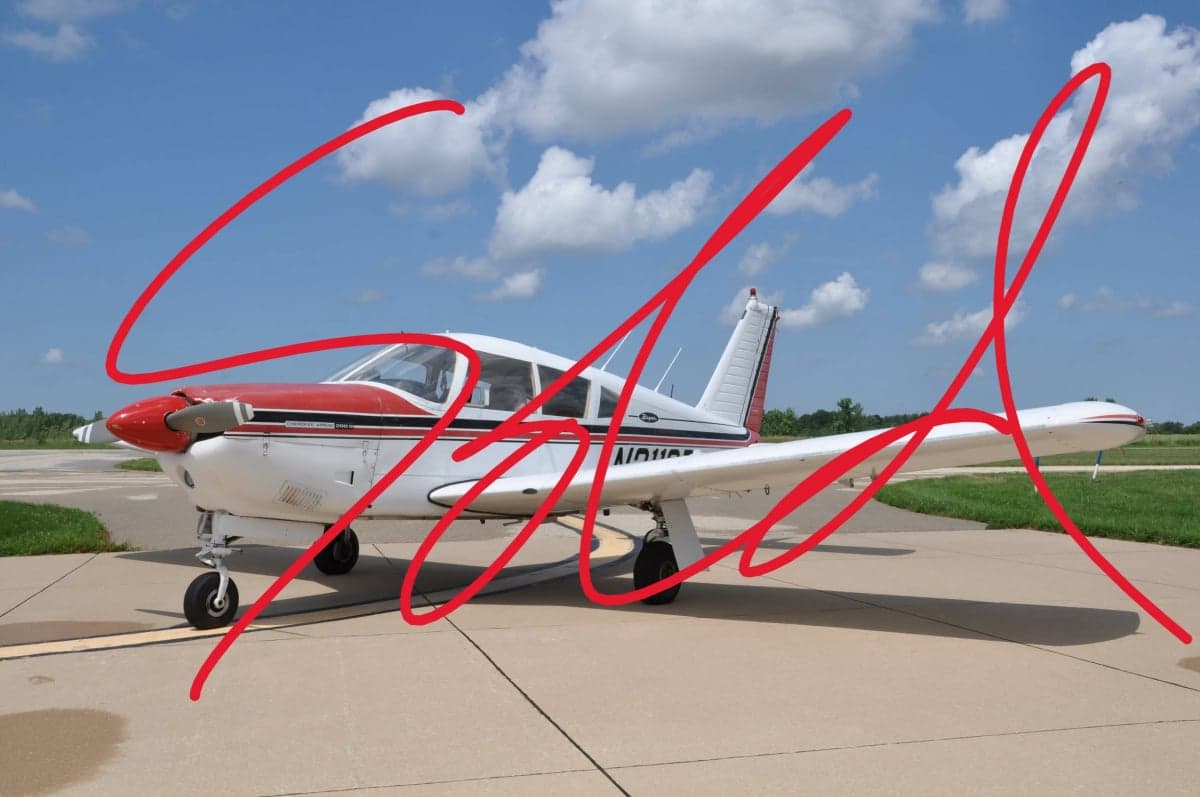 A Piper PA-28 Cherokee is parked on the tarmac with a SOLD overlay.