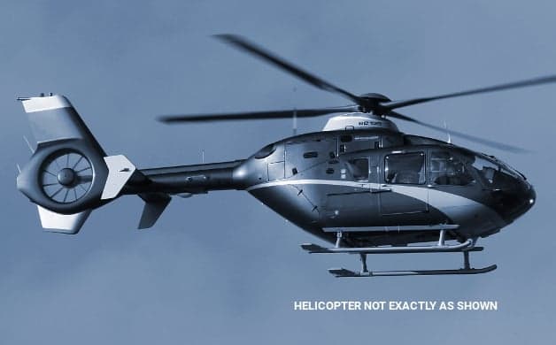 Profile view of a Eurocopter EC135 in flight.