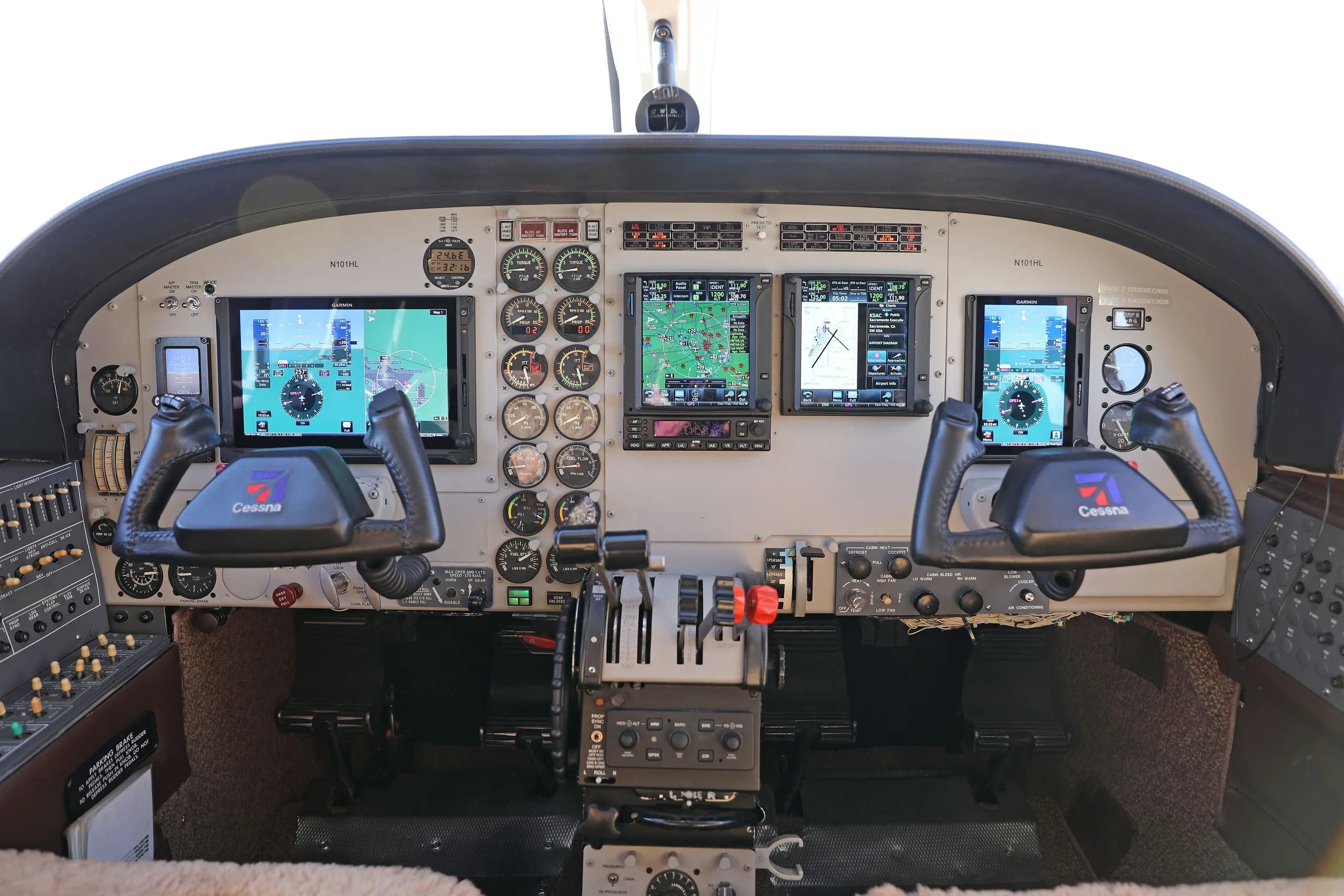 The cockpit of the Cessna 414 Chancellor, featuring modern glass panel displays and traditional analog gauges.