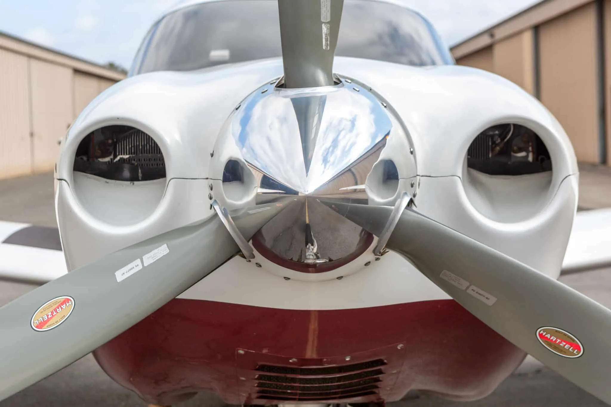 Close-up view of the propeller and nose cone of the Piper Saratoga II TC aircraft.