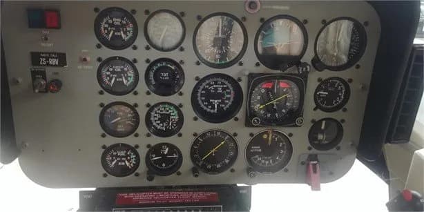 Close-up of the helicopter's instrument panel with various gauges.
