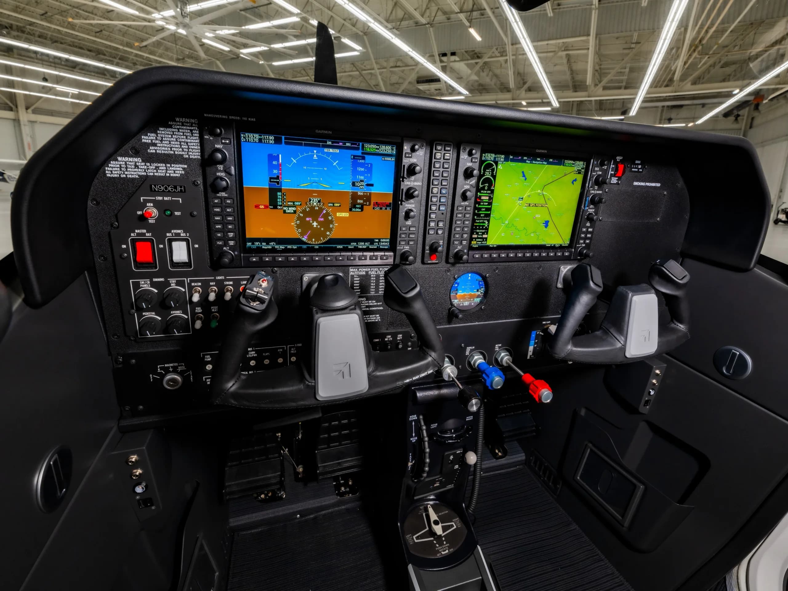 The modern glass cockpit of a Cessna Skylane N906JH features multiple digital displays and controls.