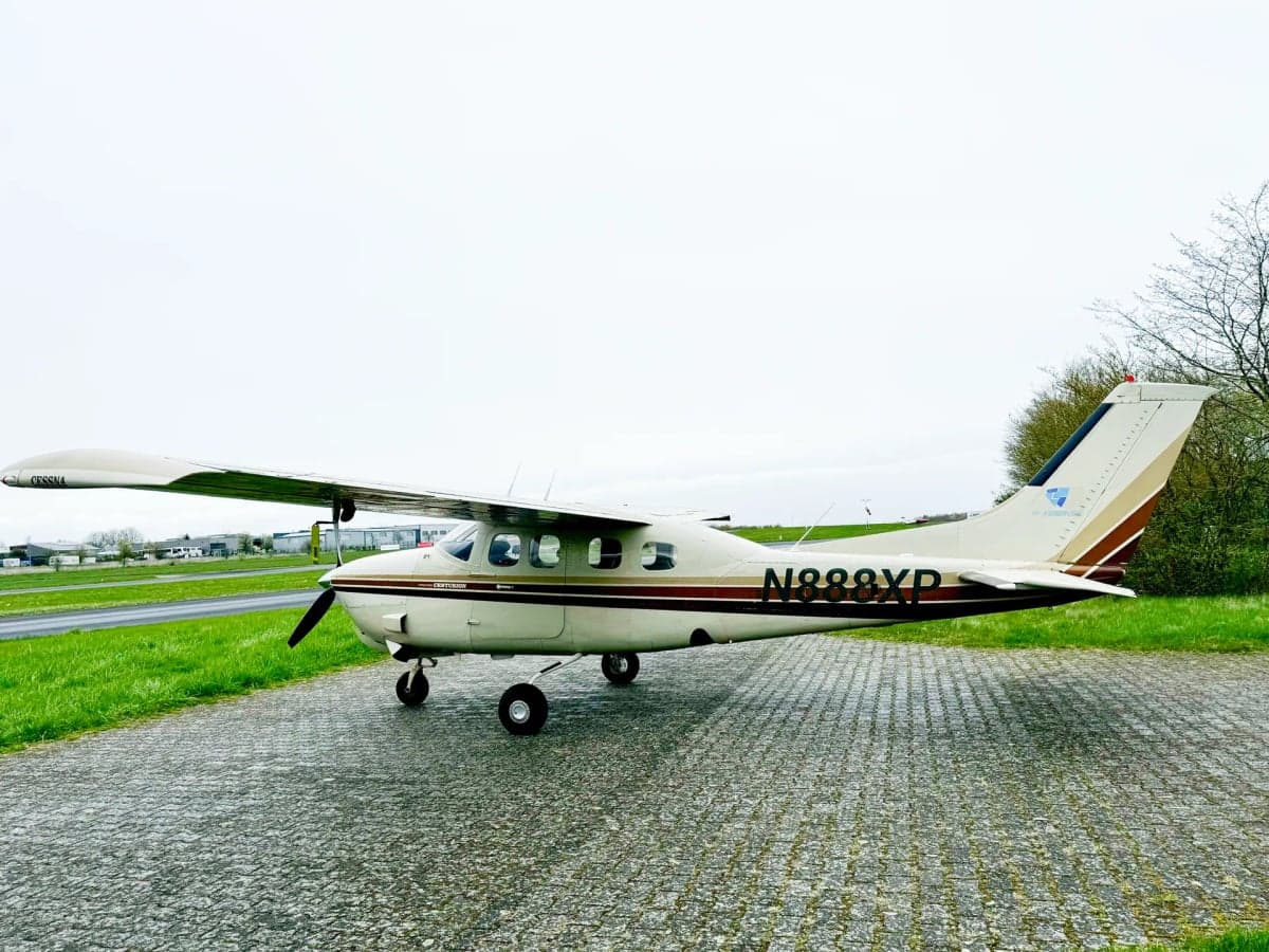 Cessna Centurion with a white and brown paint scheme on the tarmac.
