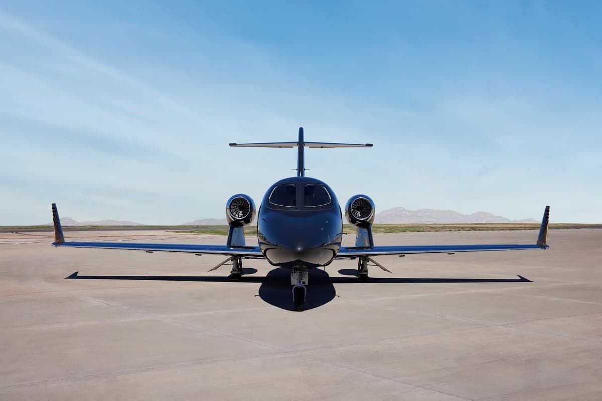 Front view of a black HondaJet on the tarmac.