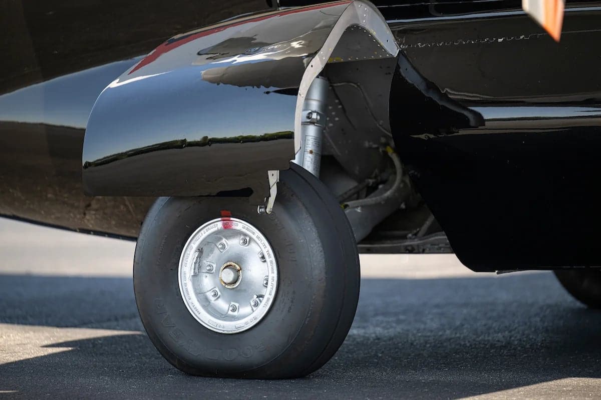 Close up of the landing gear and tire of the N33EW aircraft.