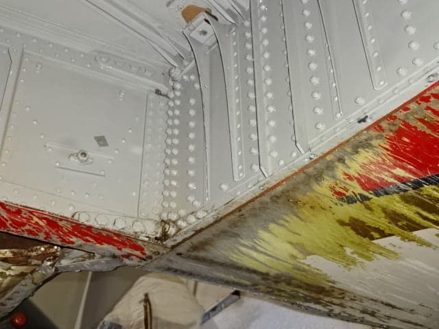 Close-up of the aircraft's internal structure with visible paint and rivets.
