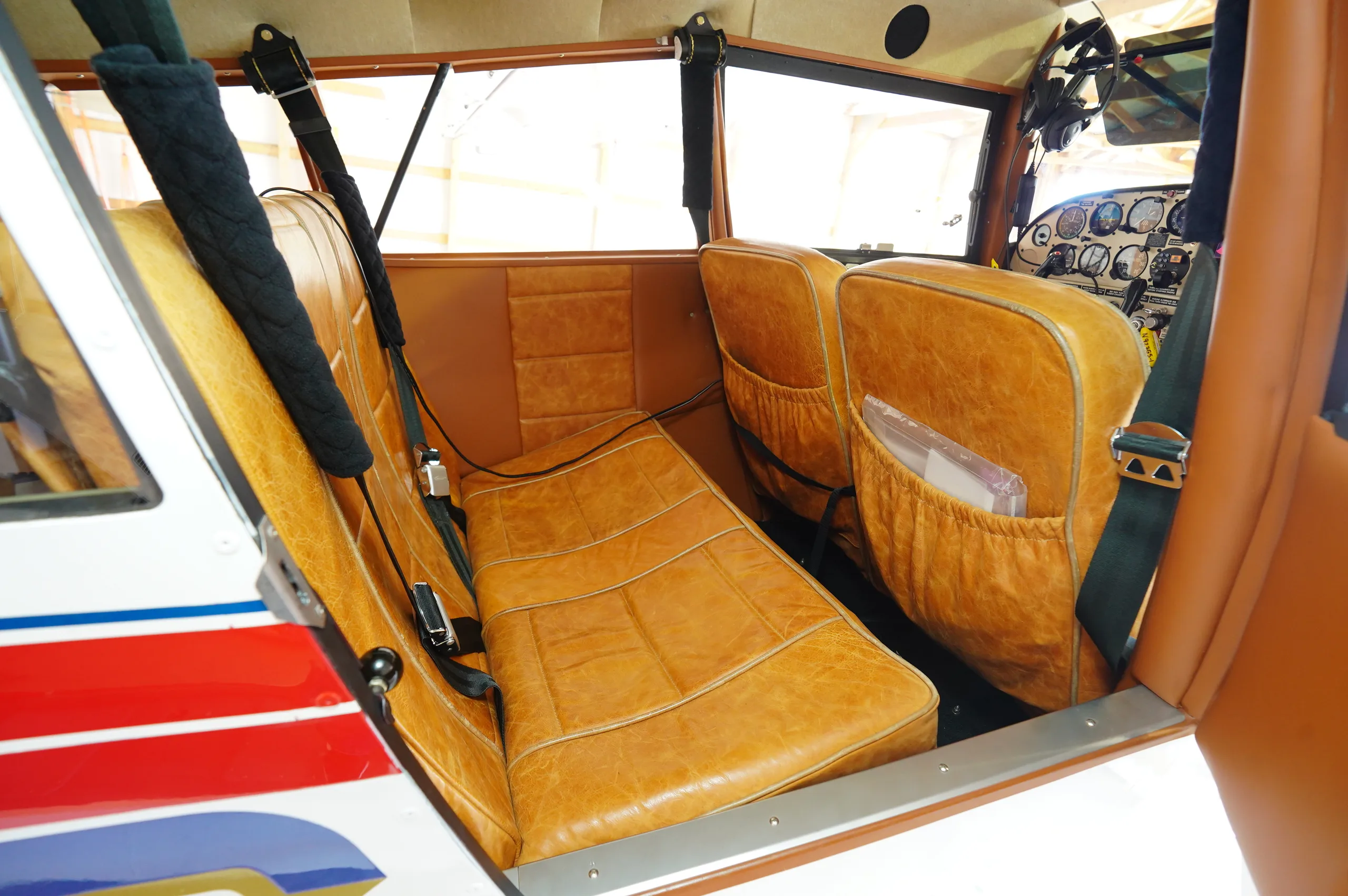Another view of the aircraft's tan leather cabin seats from a different angle.