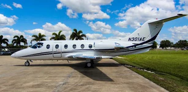 A white Hawker 400XP with registration N301AE is parked on the tarmac.