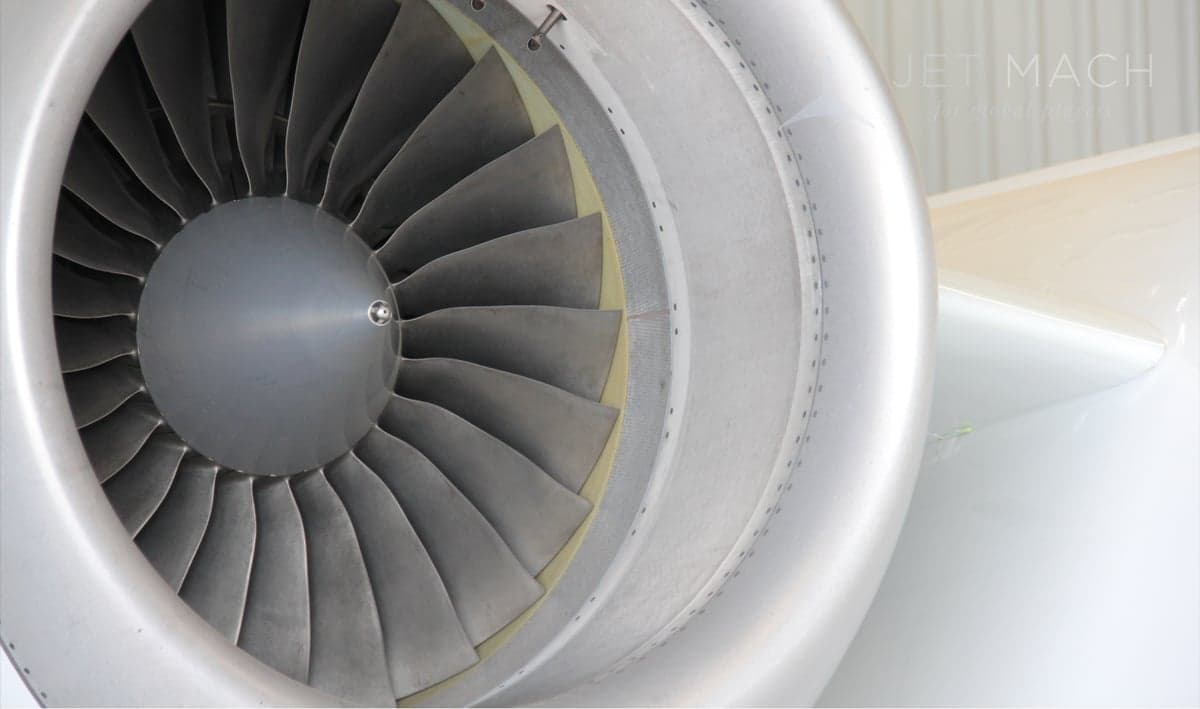 Close-up of the engine of the N317EC aircraft, showing the turbine blades.