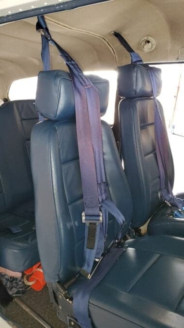 View of the blue leather seats inside the aircraft cabin.