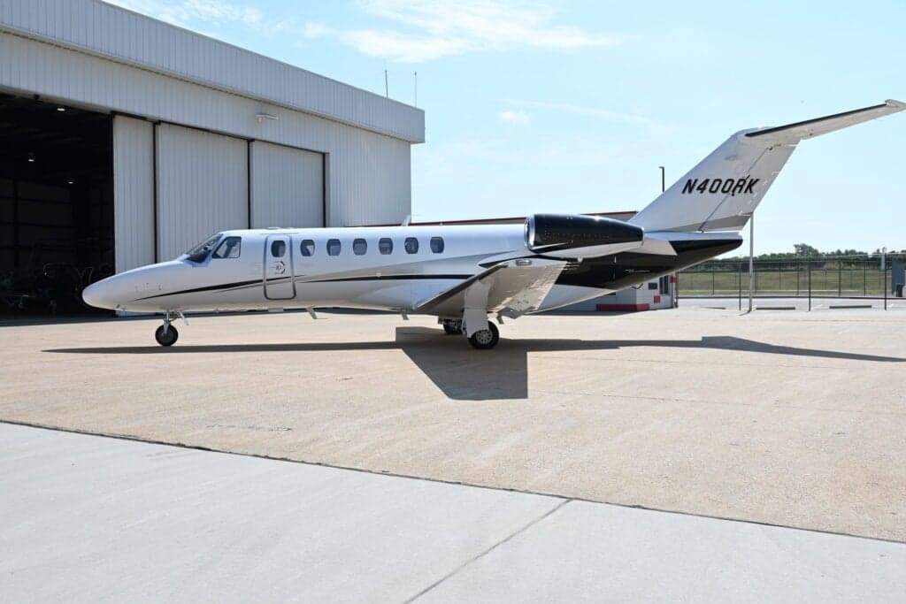N400RK Cessna Citation CJ3+ parked in front of a hangar.
