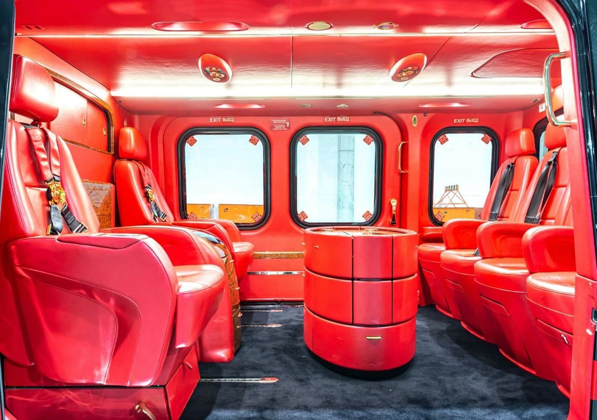 The helicopter's red leather interior features four seats and a table.