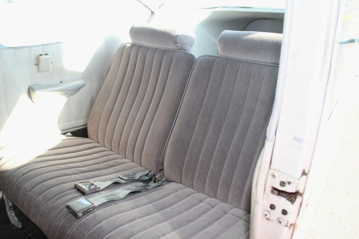 A view of the aircraft's interior showing the rear seats with gray upholstery.