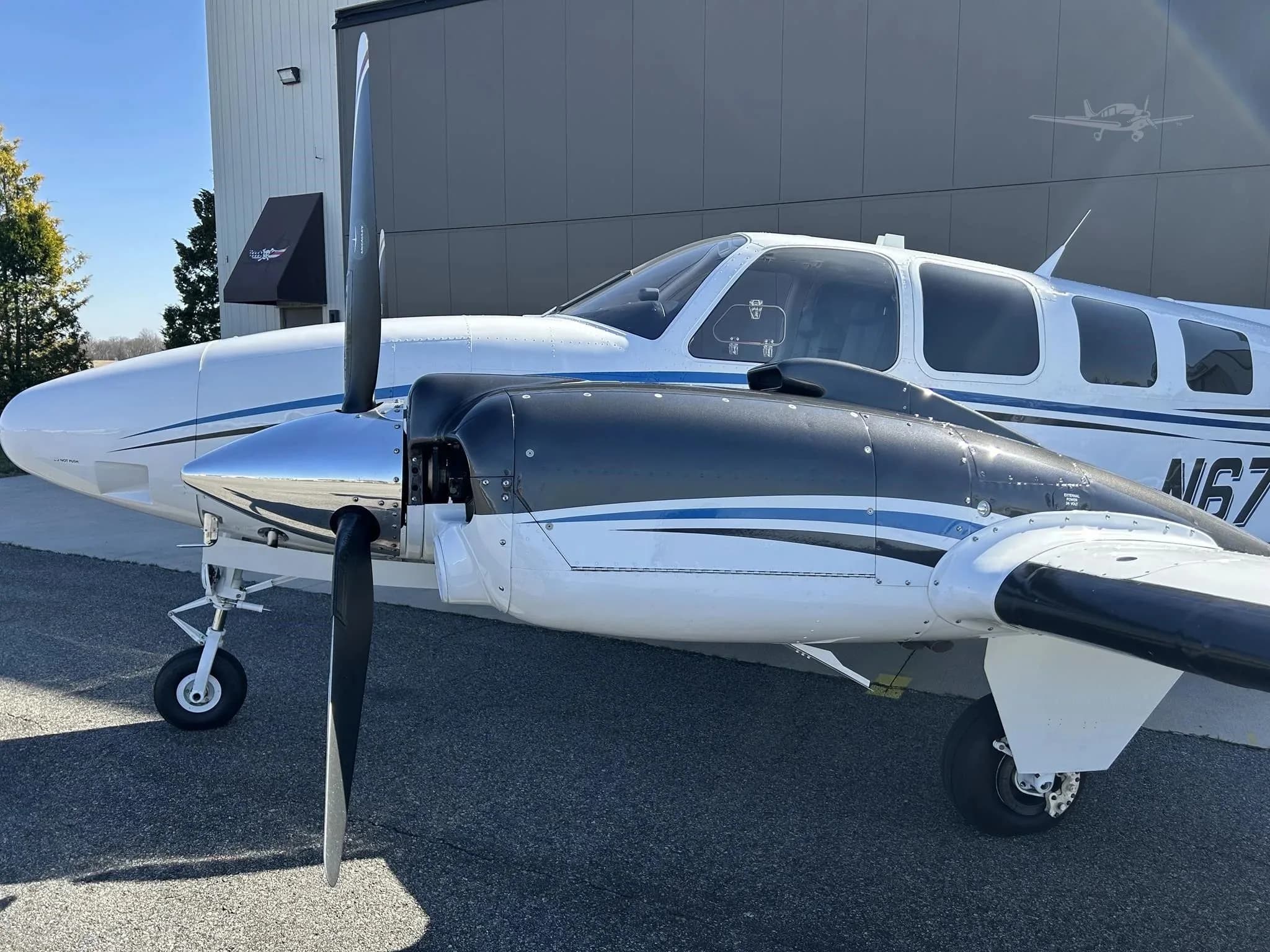 A close-up view of the front section and right engine of the Beechcraft Baron N67WM.