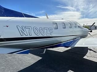 Side view of the TBM 900 aircraft showing the registration number N700ZF.