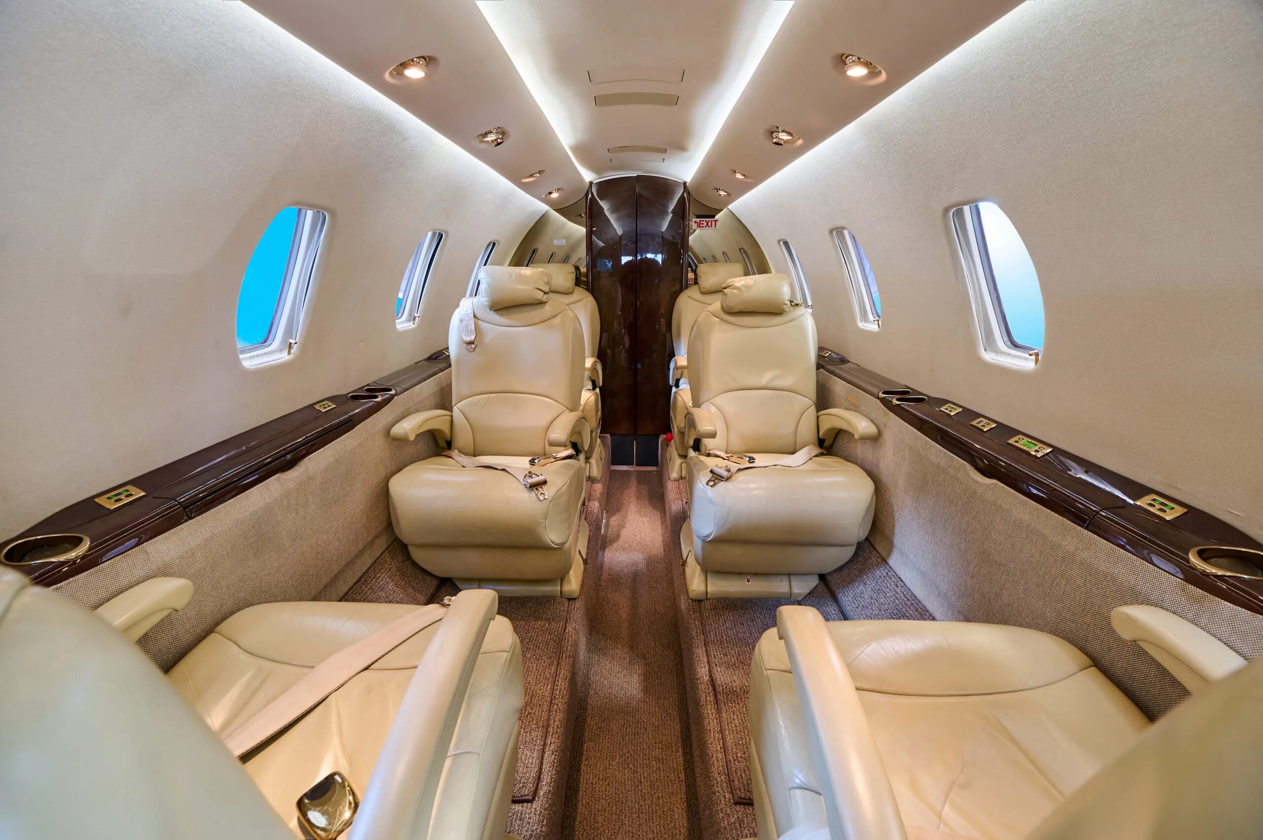 View of the Cessna Citation CJ3 cabin with four tan leather seats.