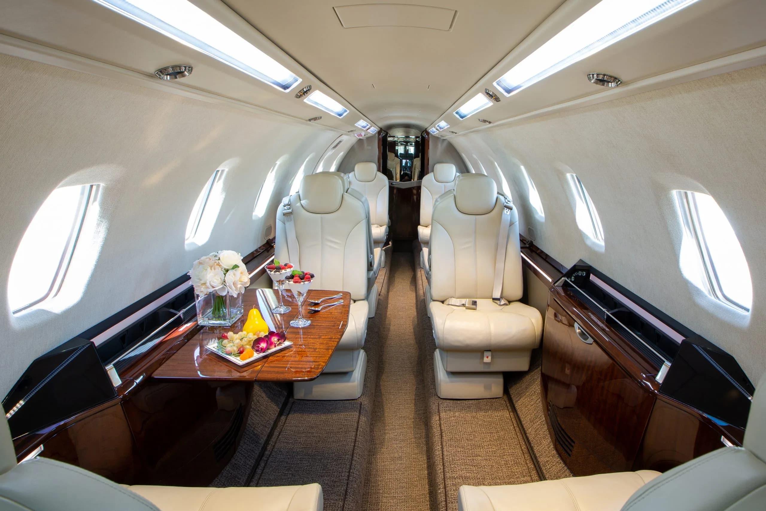 A view of the Citation CJ4 aircraft's interior, showcasing the seating and table.