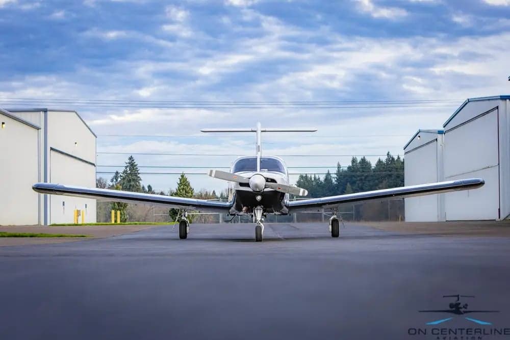 Front view of a Piper PA-32R-301 Saratoga SP, registration N541MV, parked on the tarmac.