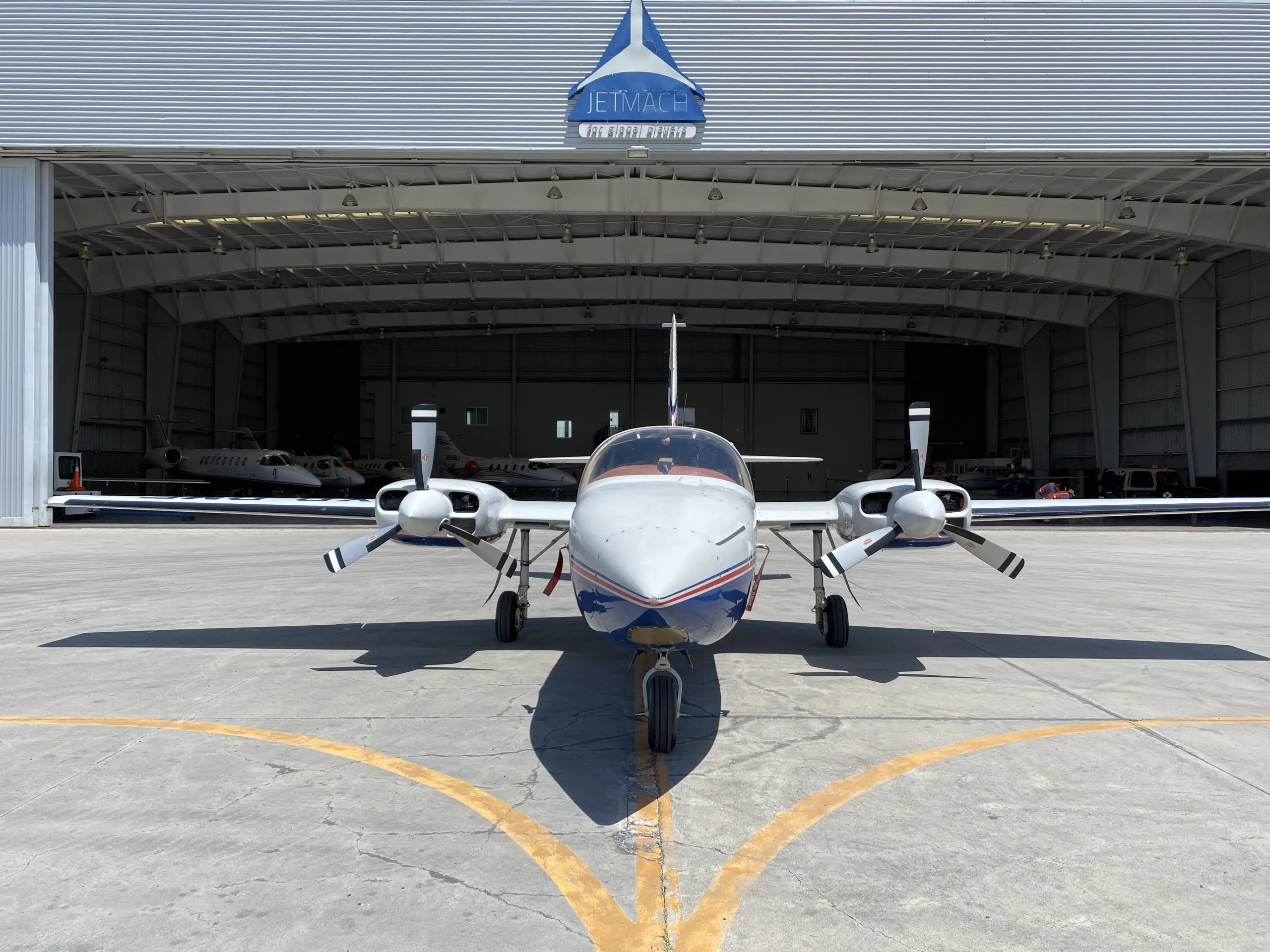 Front view of the XB-DMF aircraft parked in front of a hangar.