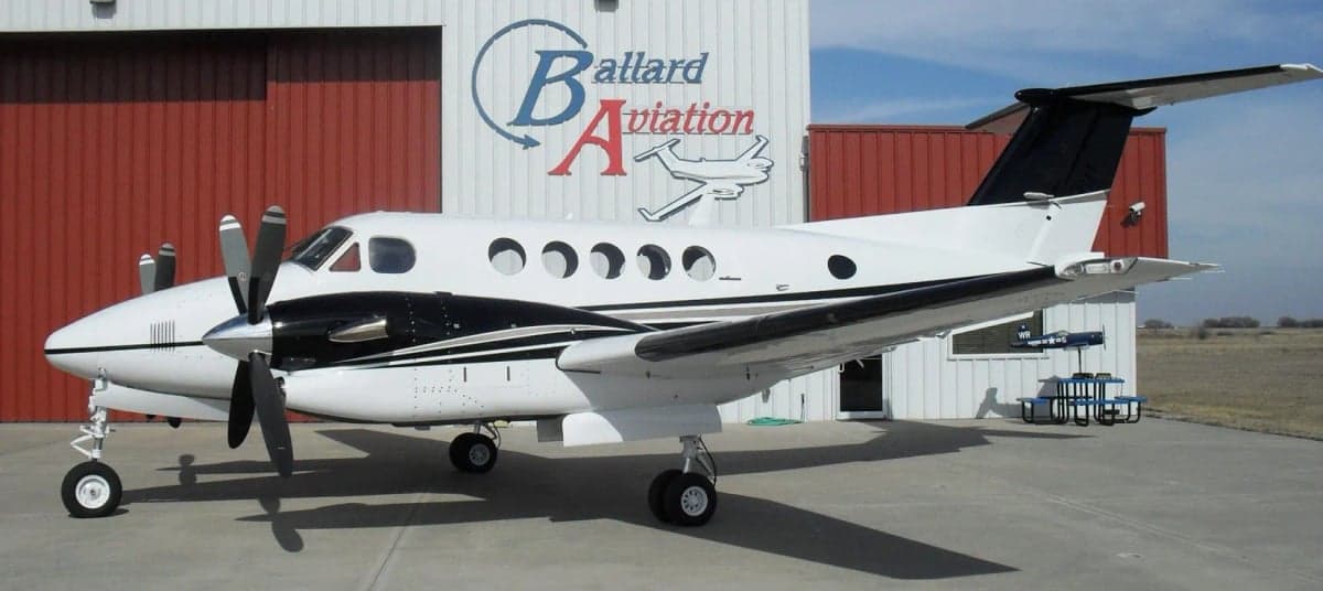 King Air aircraft parked in front of a hangar.