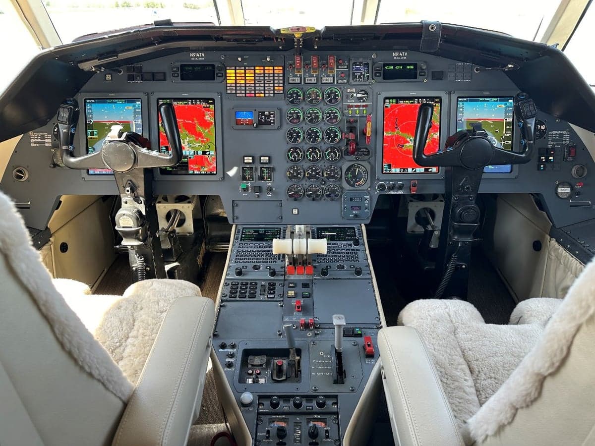 Full view of the aircraft's cockpit with instrument panel and controls.