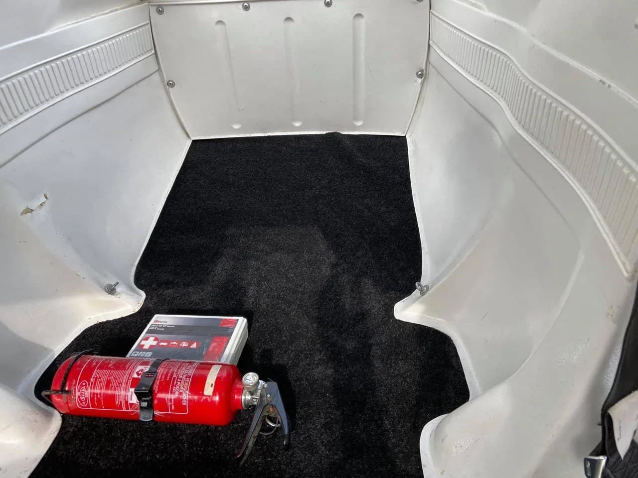 View of the Cessna 150 baggage compartment with a fire extinguisher.