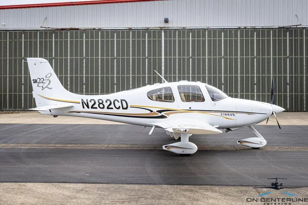 Side view of Cirrus SR22T aircraft N282CD on the tarmac.