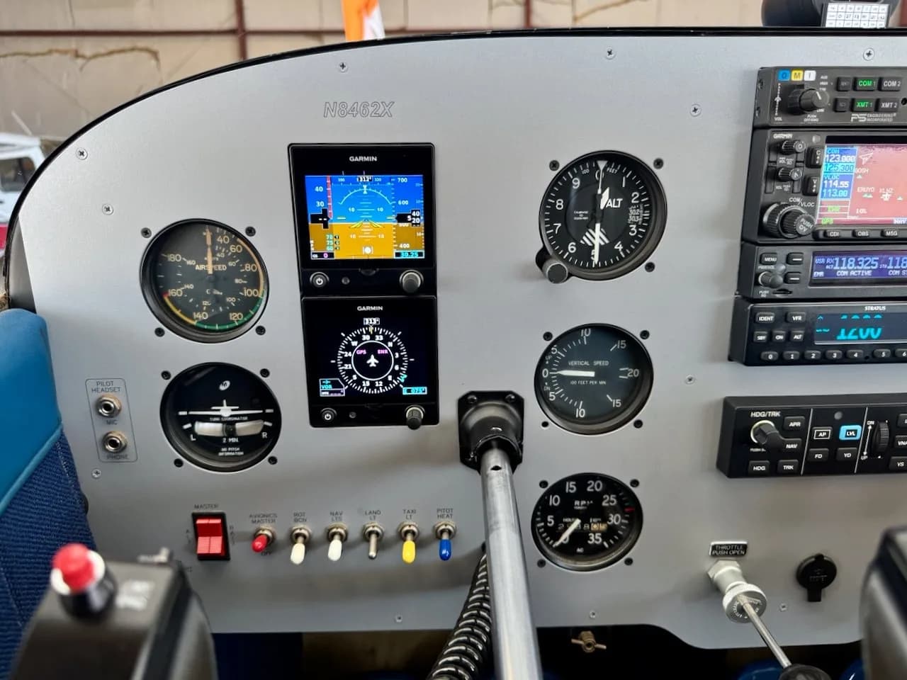 A close-up of the left side of the Cessna 172 cockpit, N8462X, showing flight instruments and a Garmin display.
