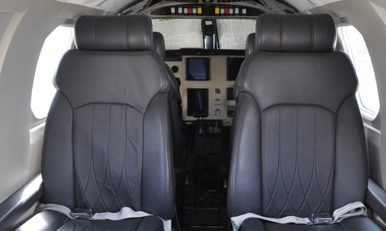 Close-up of the front seats in the aircraft cabin.