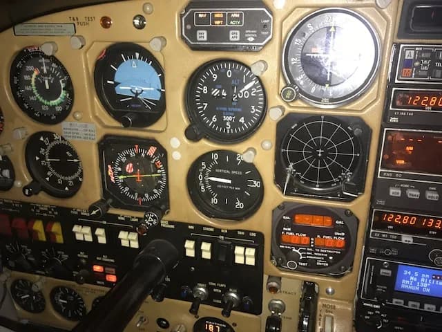 A close-up view of an aircraft's instrument panel with various gauges and avionics.