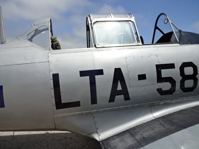 Close-up of the side of the silver T-6 Texan aircraft showing the LTA-584 marking.