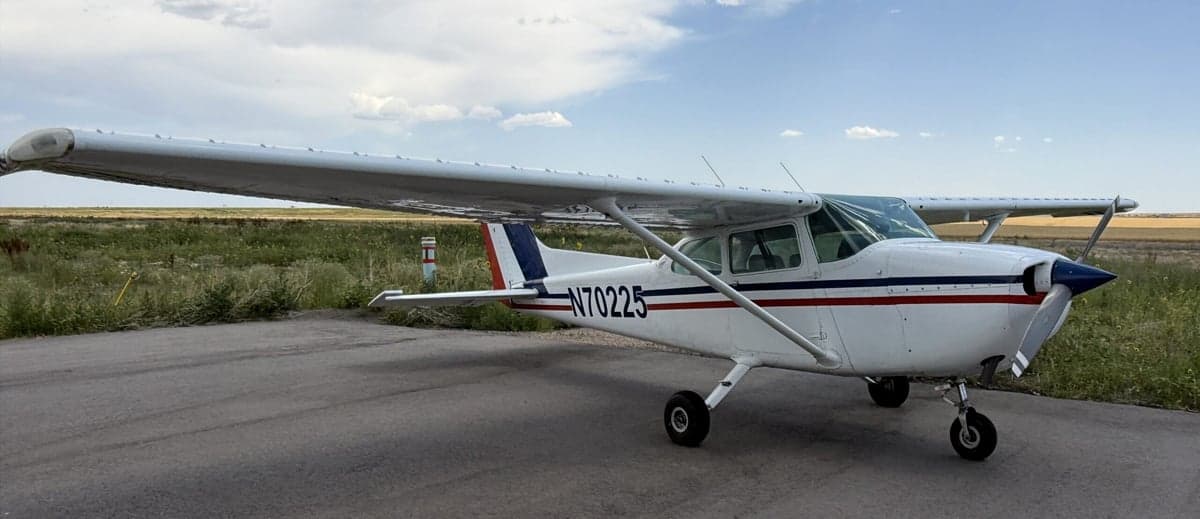 A Cessna 172 Skyhawk with tail number N70225 parked on an asphalt surface.