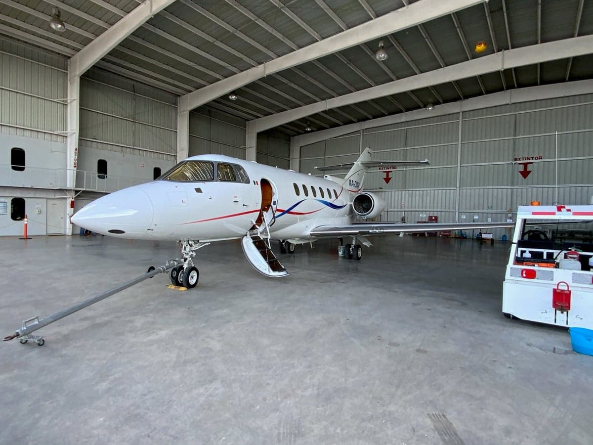 XA-DAR Falcon 50 parked in a hangar with the door open.