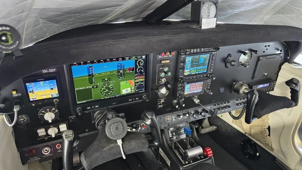 The cockpit features a modern glass panel with multiple displays and controls.
