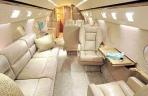 The interior of the aircraft features leather seats and a sofa.